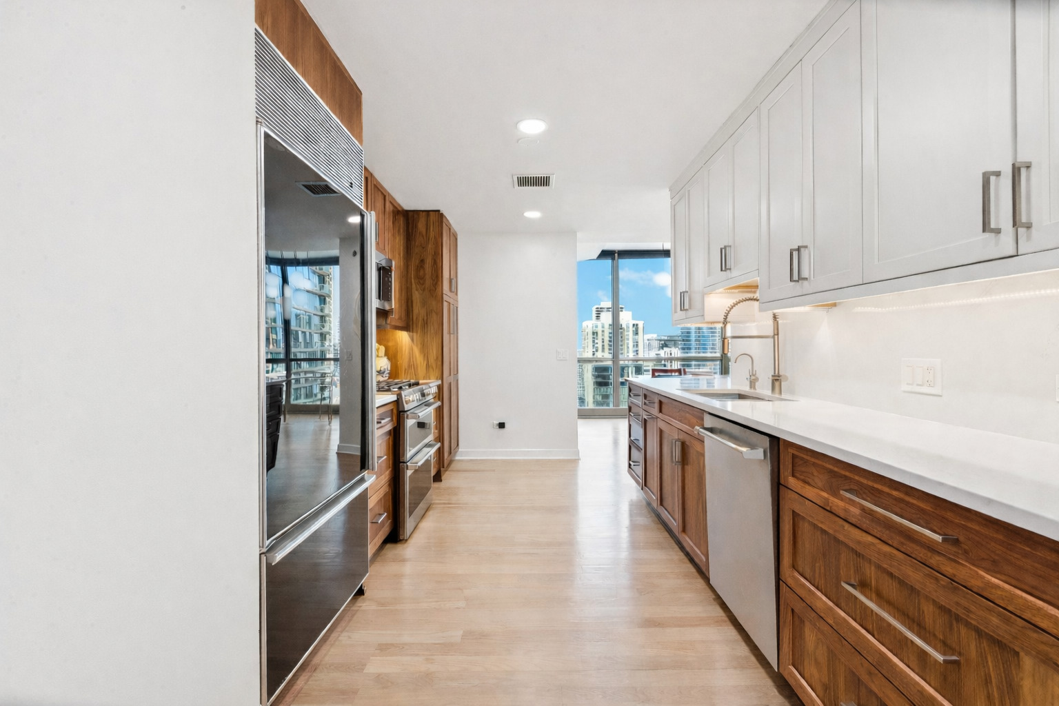 21 East Huron Street, Unit 1806 Chicago, IL 60611 - Photo 4 of 43 a kitchen with granite countertop a refrigerator and a sink