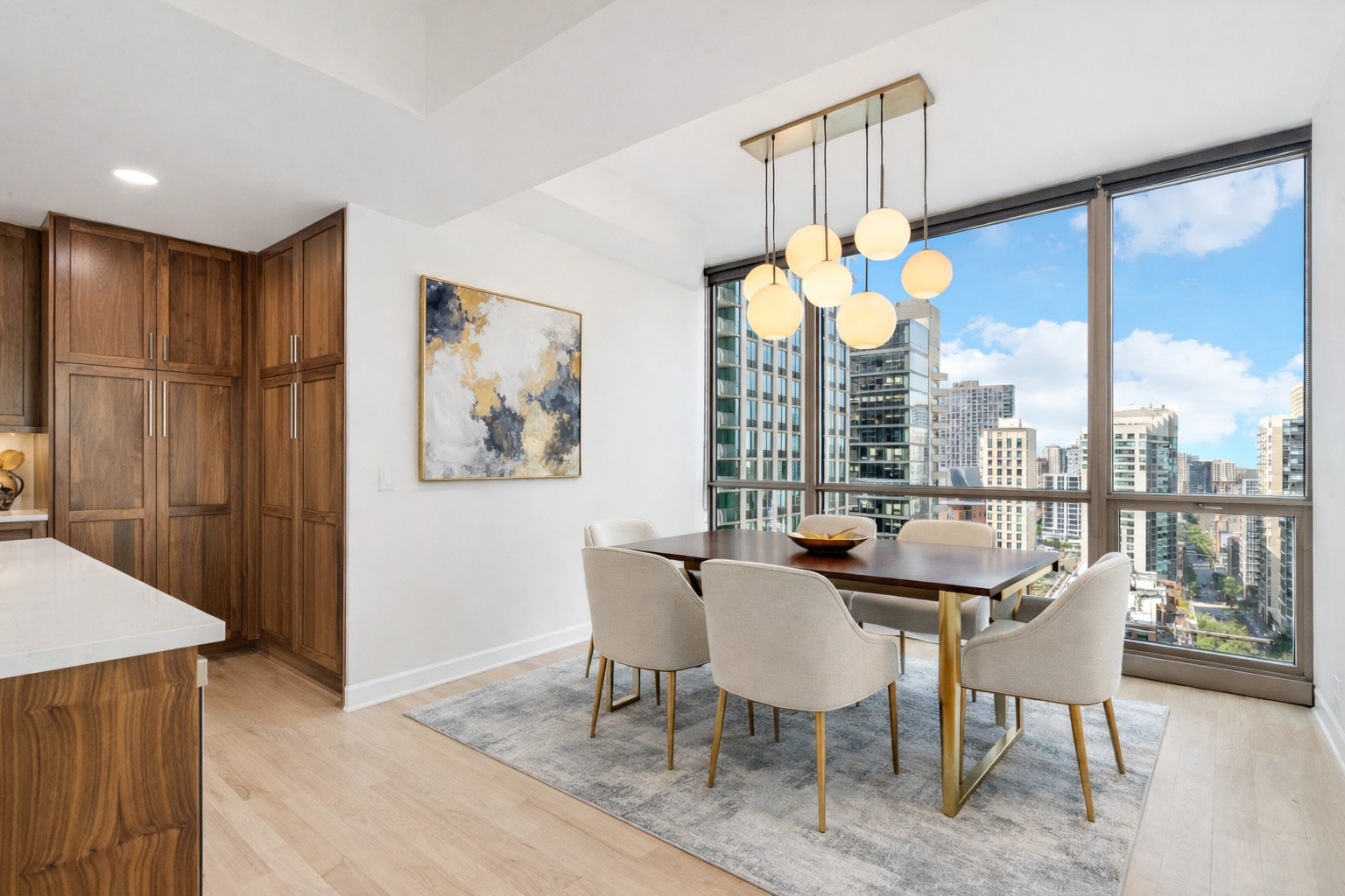 21 East Huron Street, Unit 1806 Chicago, IL 60611 - Photo 10 of 43 a dining room with furniture a chandelier and a large window