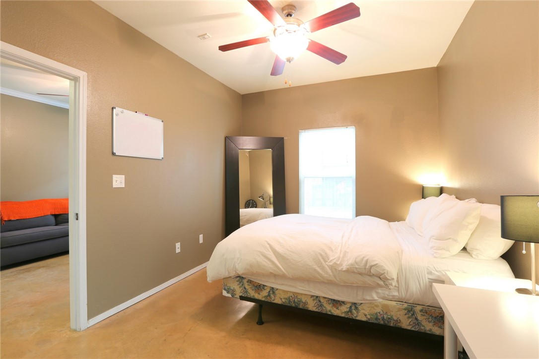 910 West 25th Street, Unit 502 Austin, TX 78705 - Photo 11 of 26 a bedroom with a bed and a chandelier