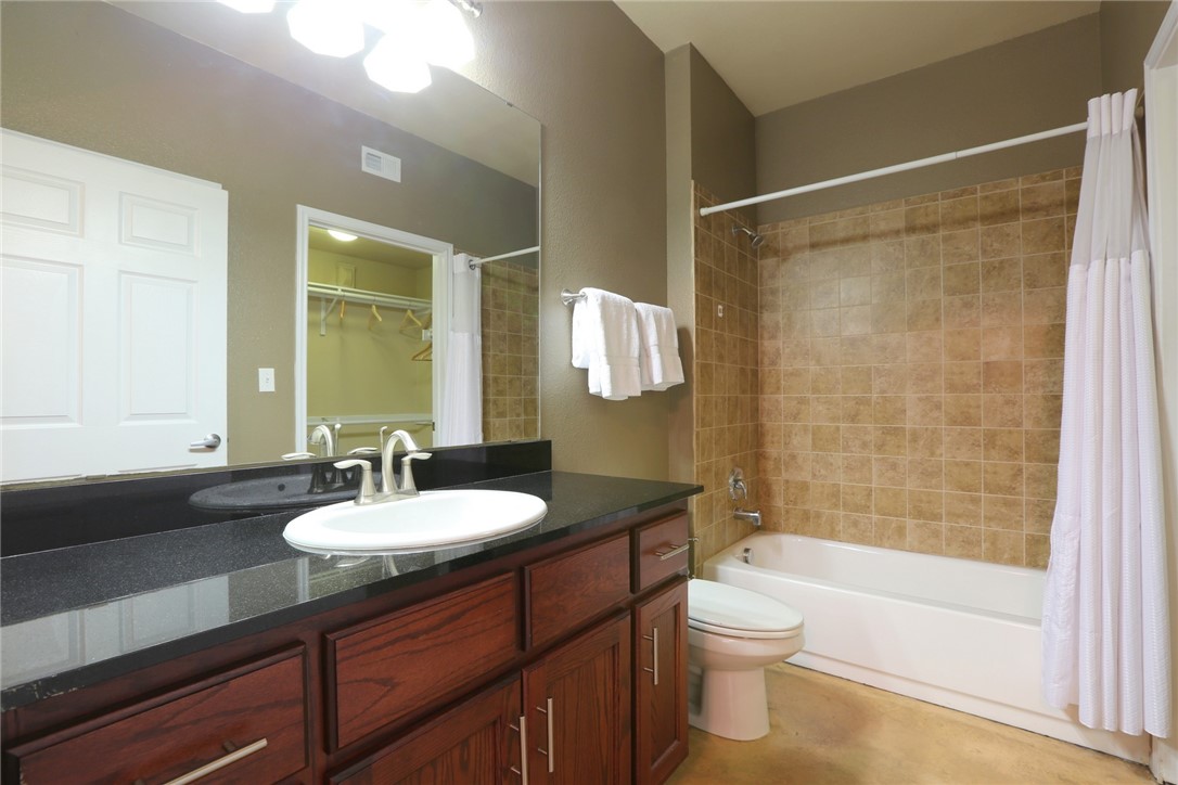 910 West 25th Street, Unit 502 Austin, TX 78705 - Photo 13 of 26 a bathroom with a sink a toilet and shower
