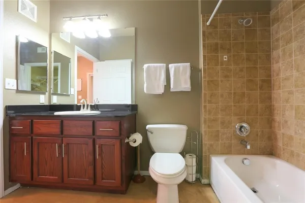 a bathroom with a sink a toilet and bathtub