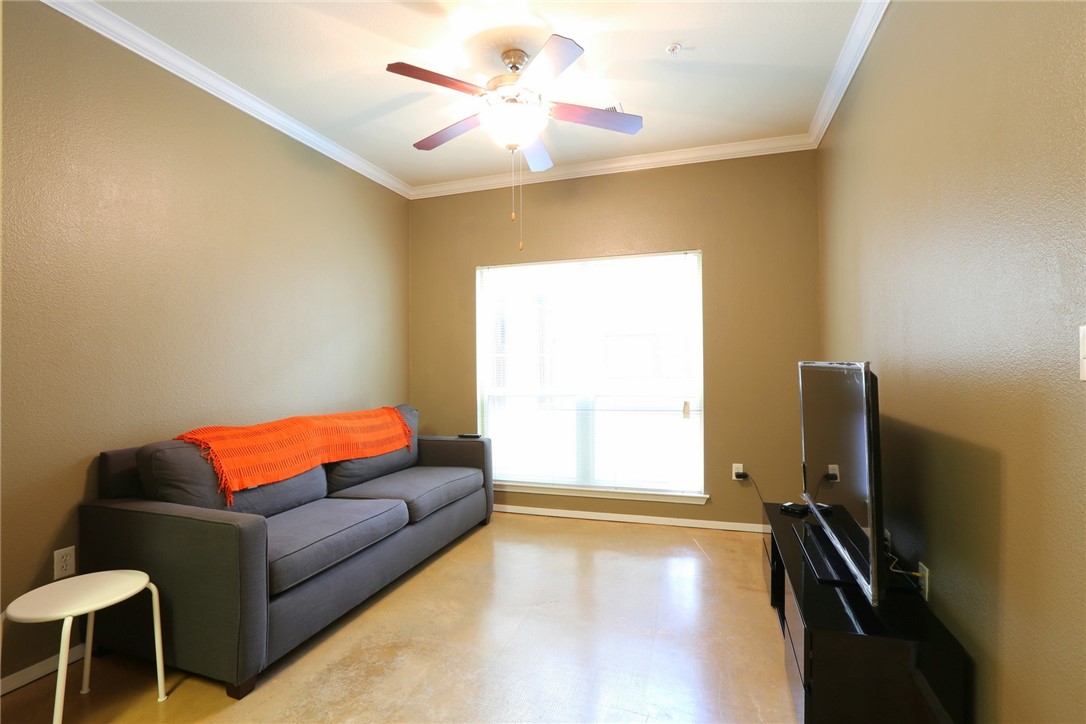 910 West 25th Street, Unit 502 Austin, TX 78705 - Photo 2 of 26 a living room with furniture and a flat screen tv