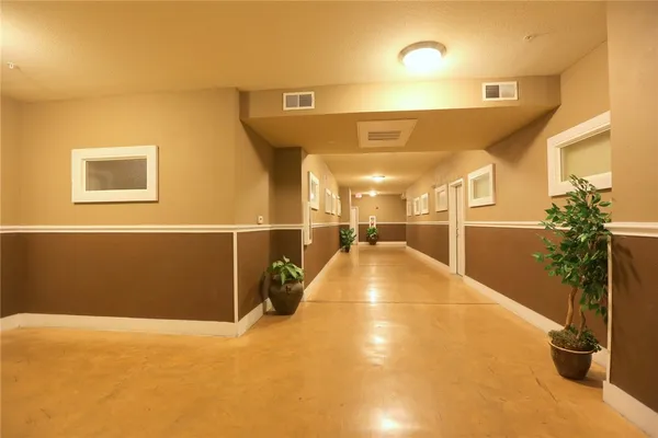 a view of a hallway with potted plants