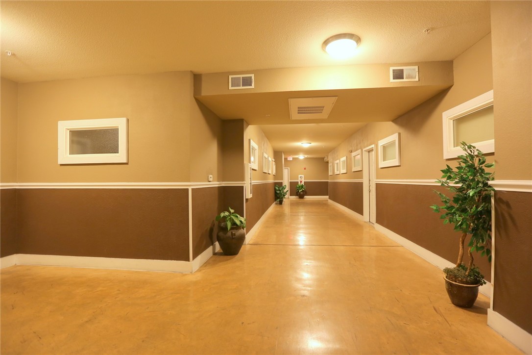 910 West 25th Street, Unit 502 Austin, TX 78705 - Photo 25 of 26 a view of a hallway with potted plants
