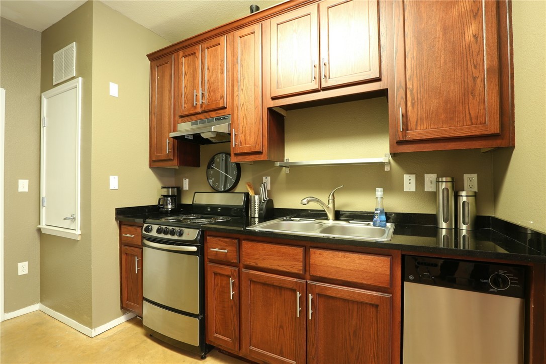 910 West 25th Street, Unit 502 Austin, TX 78705 - Photo 6 of 26 a kitchen with stainless steel appliances granite countertop a stove a sink and a microwave