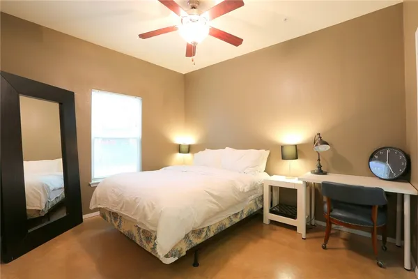 a bedroom with a bed and a table