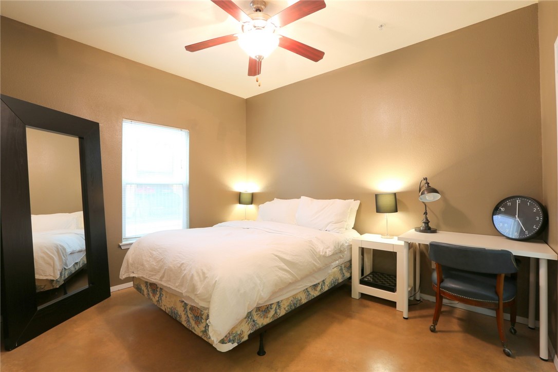 910 West 25th Street, Unit 502 Austin, TX 78705 - Photo 10 of 26 a bedroom with a bed and a table