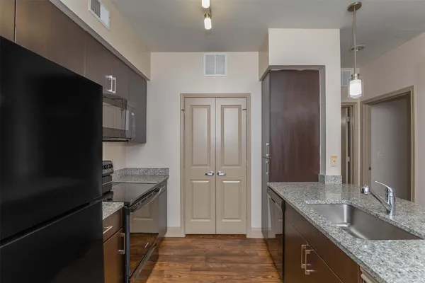 a kitchen with a sink stove and refrigerator