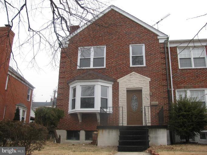 1614 Burnwood Road Baltimore, MD 21239 - Photo 1 of 11 a front view of a house with a yard