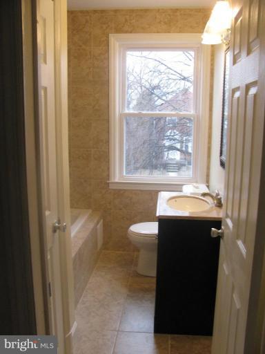 1614 Burnwood Road Baltimore, MD 21239 - Photo 2 of 11 a bathroom with a sink toilet and shower