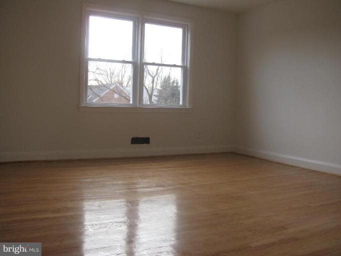 1614 Burnwood Road Baltimore, MD 21239 - Photo 3 of 11 a view of an empty room with a window