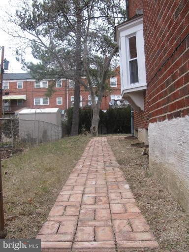 1614 Burnwood Road Baltimore, MD 21239 - Photo 4 of 11 a view of a brick house with a yard