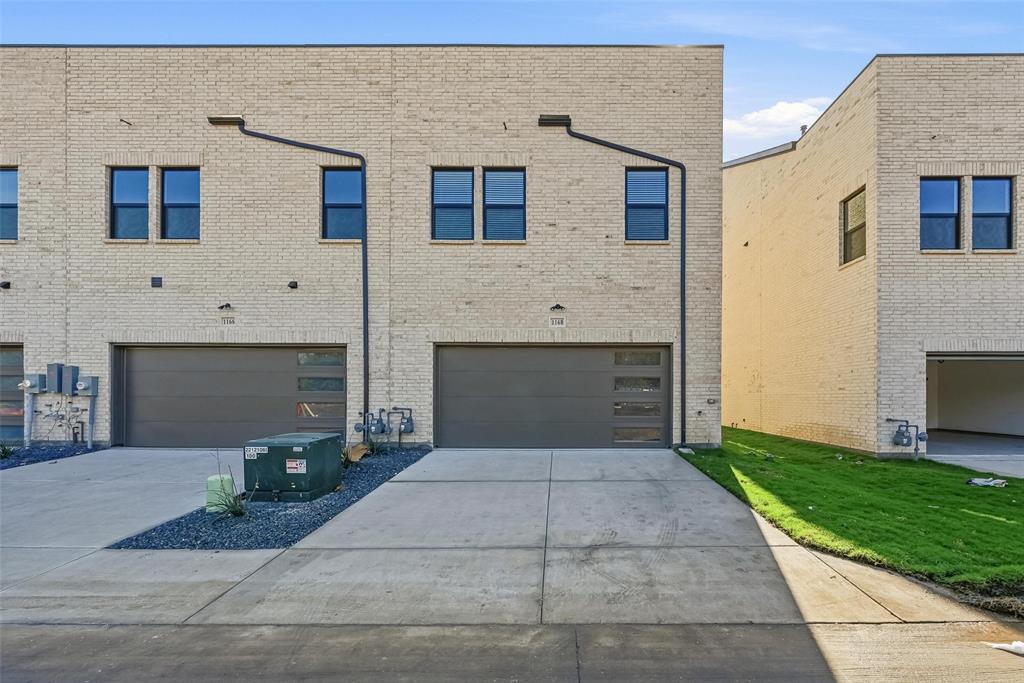 1173 Doris May Drive Allen, TX 75013 - Photo 4 of 4 Rear view of property with concrete driveway, an attached garage, and brick siding