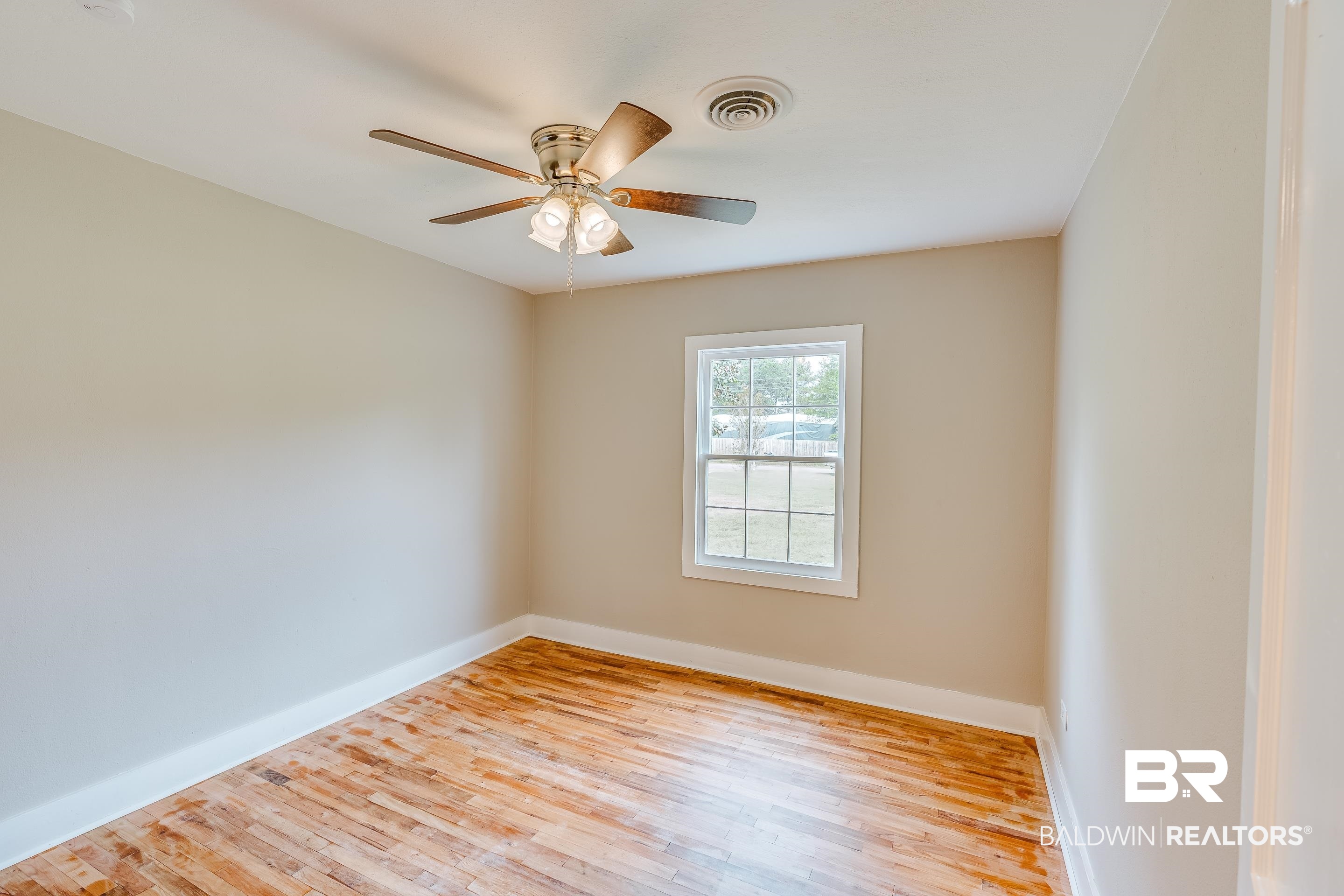 8001 16th Street Irvington, AL 36544 - Photo 18 of 35 Spare room with wood finished floors and a ceiling fan