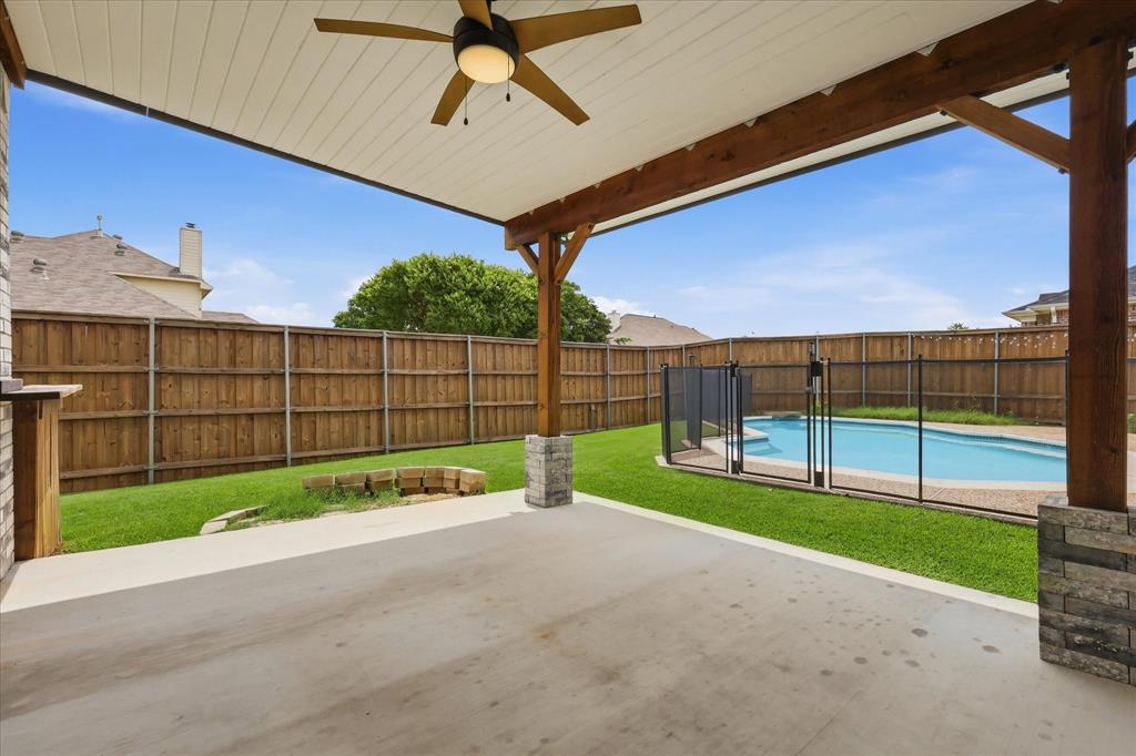4545 Ridgepointe Drive The Colony, TX 75056 - Photo 10 of 37 Covered patio with a ceiling fan, stone-wrapped structural columns, and exposed wood beams