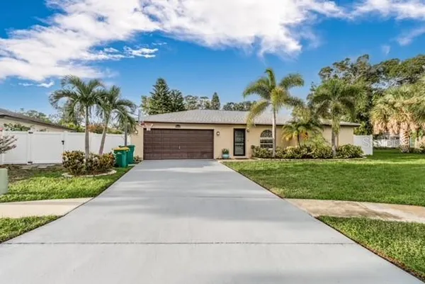 a front view of house with yard and green space