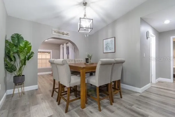a view of a dining room with furniture and wooden floor