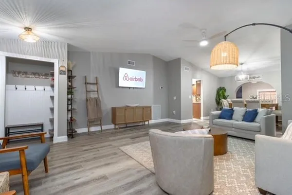 a living room with furniture and a chandelier