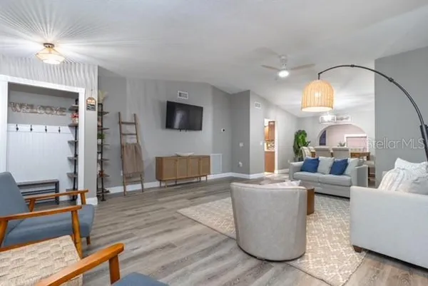 a living room with furniture a fireplace and a flat screen tv