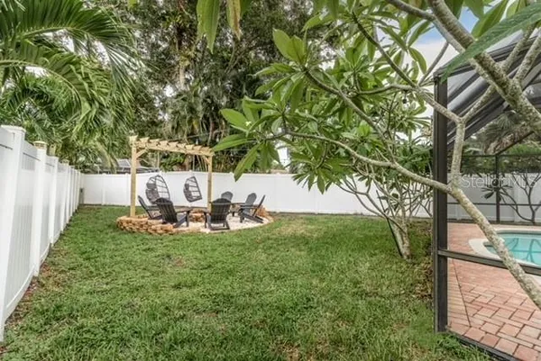 a view of a chairs and table in backyard
