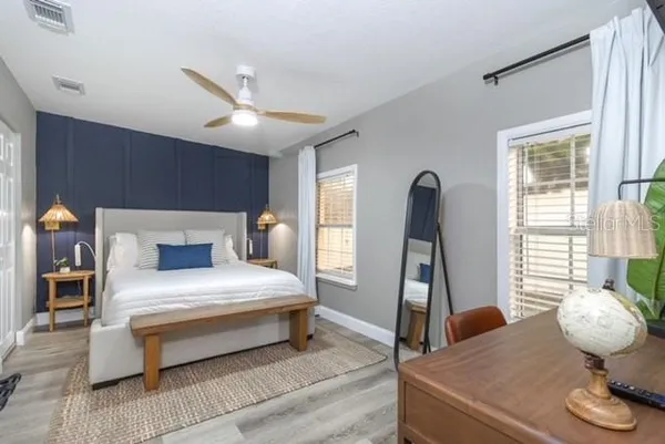 a bedroom with a bed and wooden floor