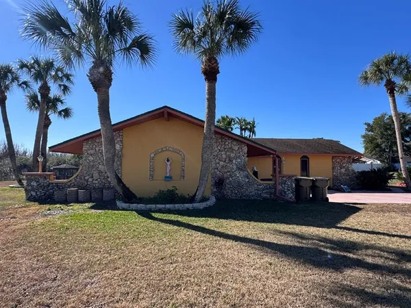 a view of a house with backyard porch and sitting area