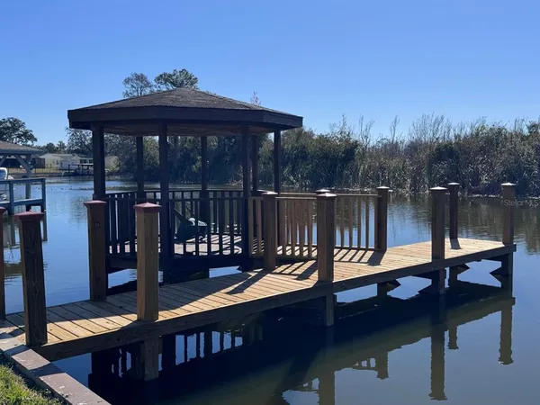 a view of lake with boats and trees in the background