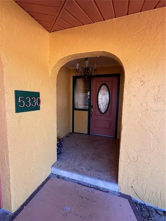 a view of a living room with hardwood floor and windows