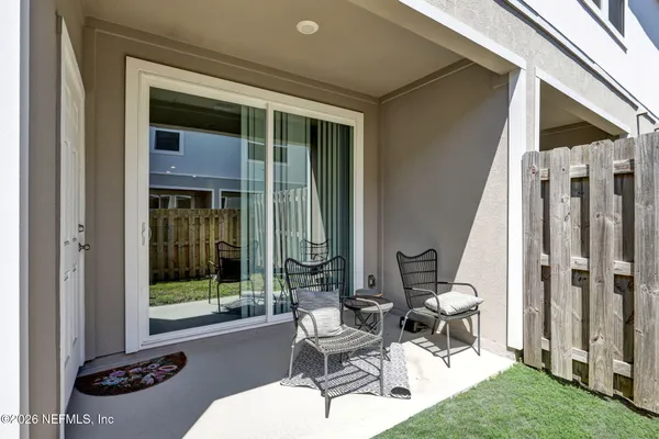 a building outdoor space with patio furniture and potted plants