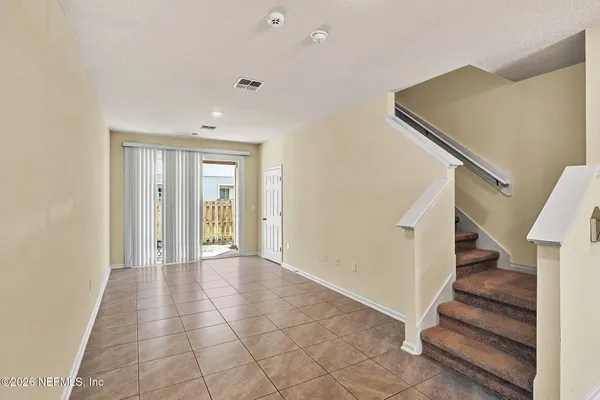 a view of entryway with wooden floor and stairs