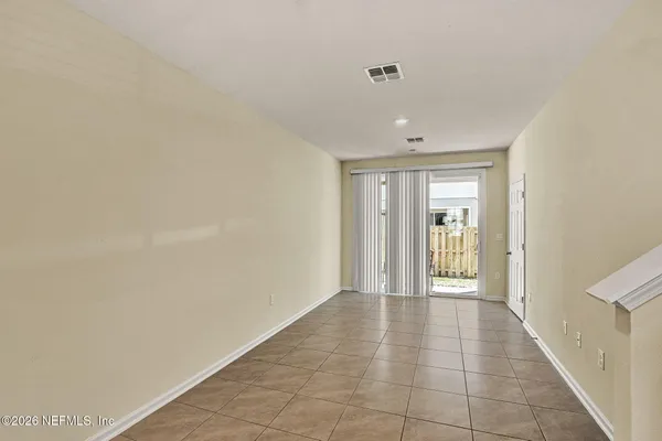 a view of an empty room and glass door