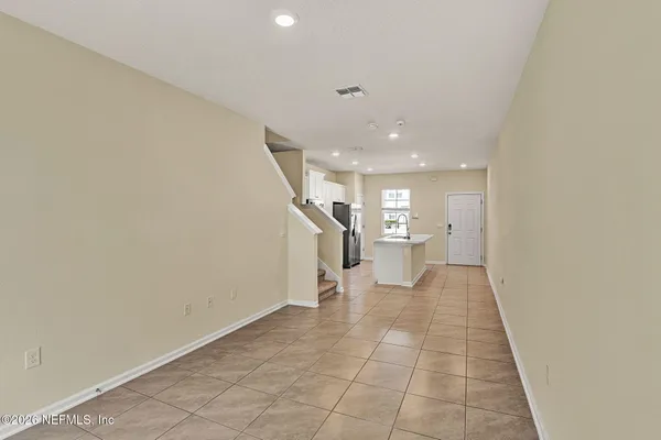 a view of a hallway with a couch and a living room