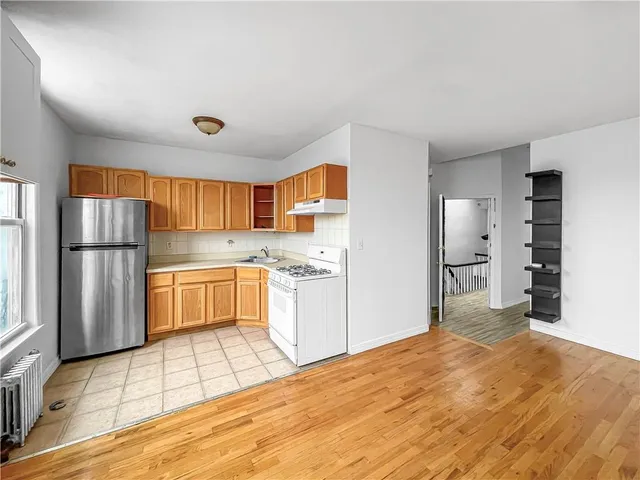 a kitchen with stainless steel appliances a refrigerator and a stove top oven