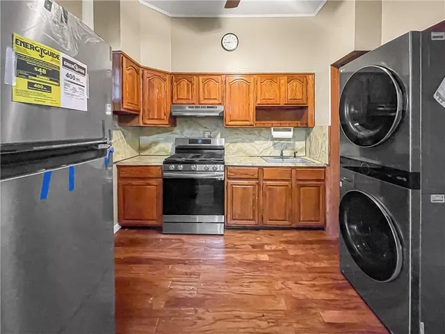 a kitchen with stainless steel appliances granite countertop a stove a sink and a microwave