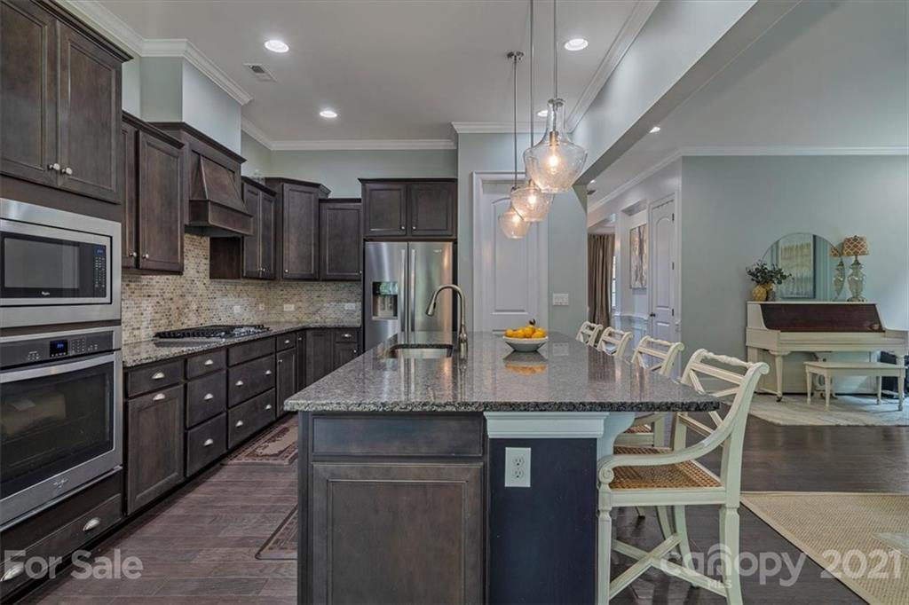 1526 Afton Way Fort Mill, SC 29708 - Photo 16 of 48 a kitchen with kitchen island granite countertop a sink cabinets and stainless steel appliances