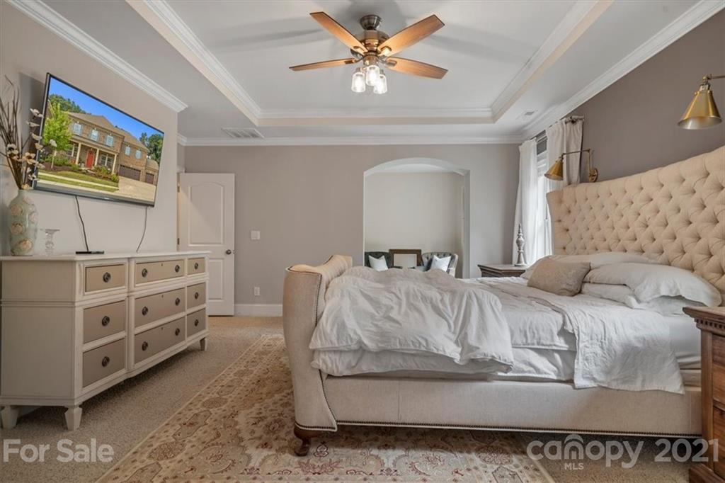 1526 Afton Way Fort Mill, SC 29708 - Photo 31 of 48 a bedroom with a bed and a chandelier