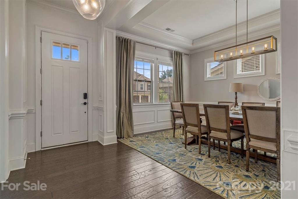 1526 Afton Way Fort Mill, SC 29708 - Photo 7 of 48 a dining room with wooden floor a chandelier a wooden table and chairs