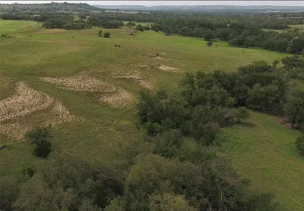 a view of a field with an ocean view