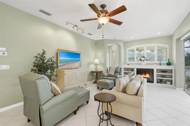 a living room with furniture a dining table and a fireplace