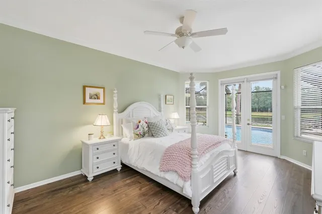 a bedroom with a bed and a large window