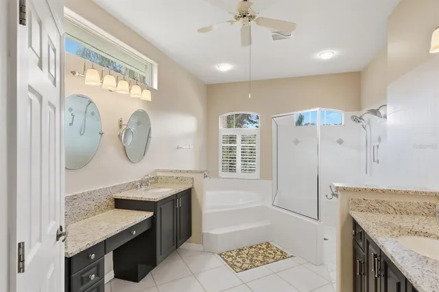 a bathroom with a granite countertop sink a mirror and a shower