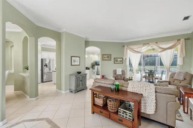 a living room with furniture and large windows