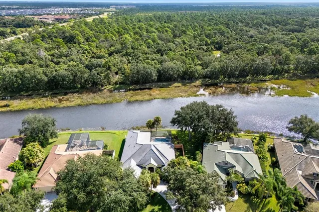 an aerial view of a house with swimming pool and outdoor space