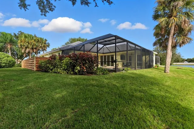 a view of a chair and table with umbrella in the yard