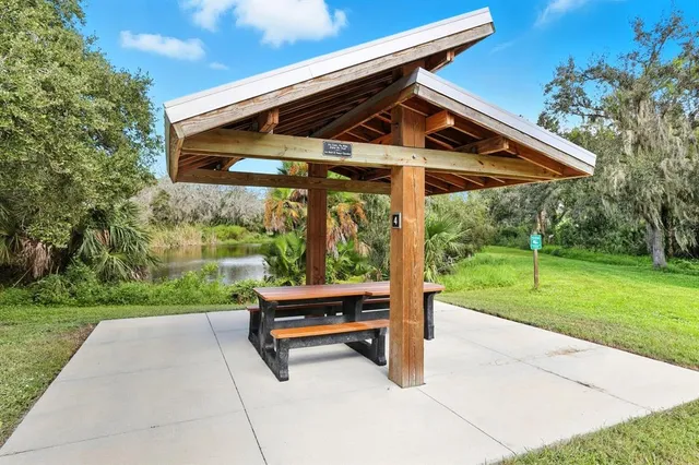 a view of backyard with wooden floor and fence