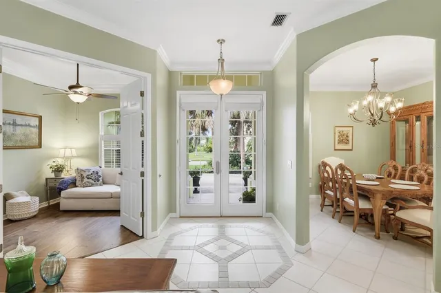 a living room with furniture and a chandelier
