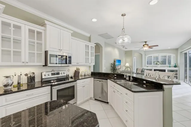 a kitchen with a sink stove and cabinets
