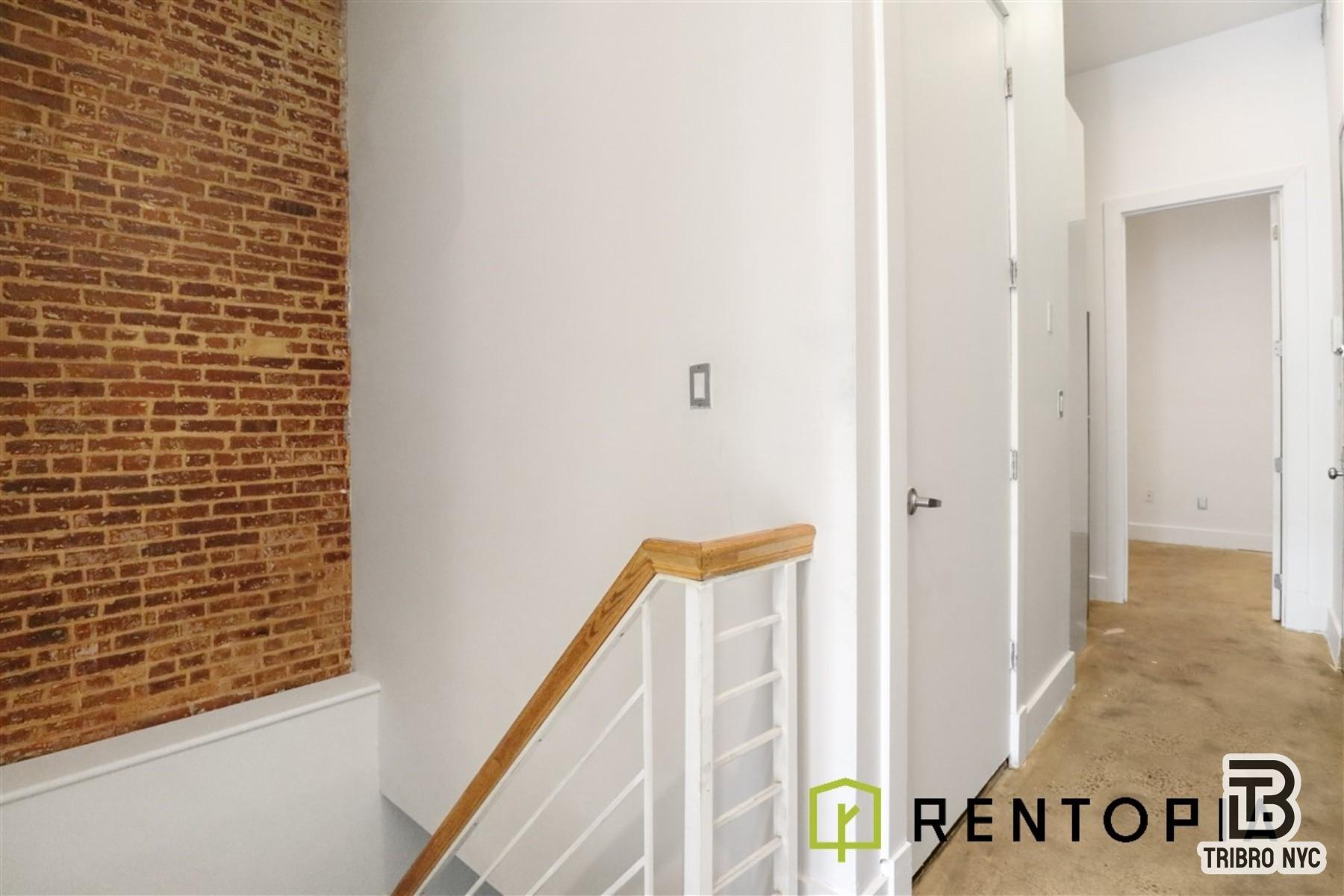 753 Lexington Avenue, Unit 1D Brooklyn, NY 11221 - Photo 4 of 8 a view of a hallway with wooden door and stairs