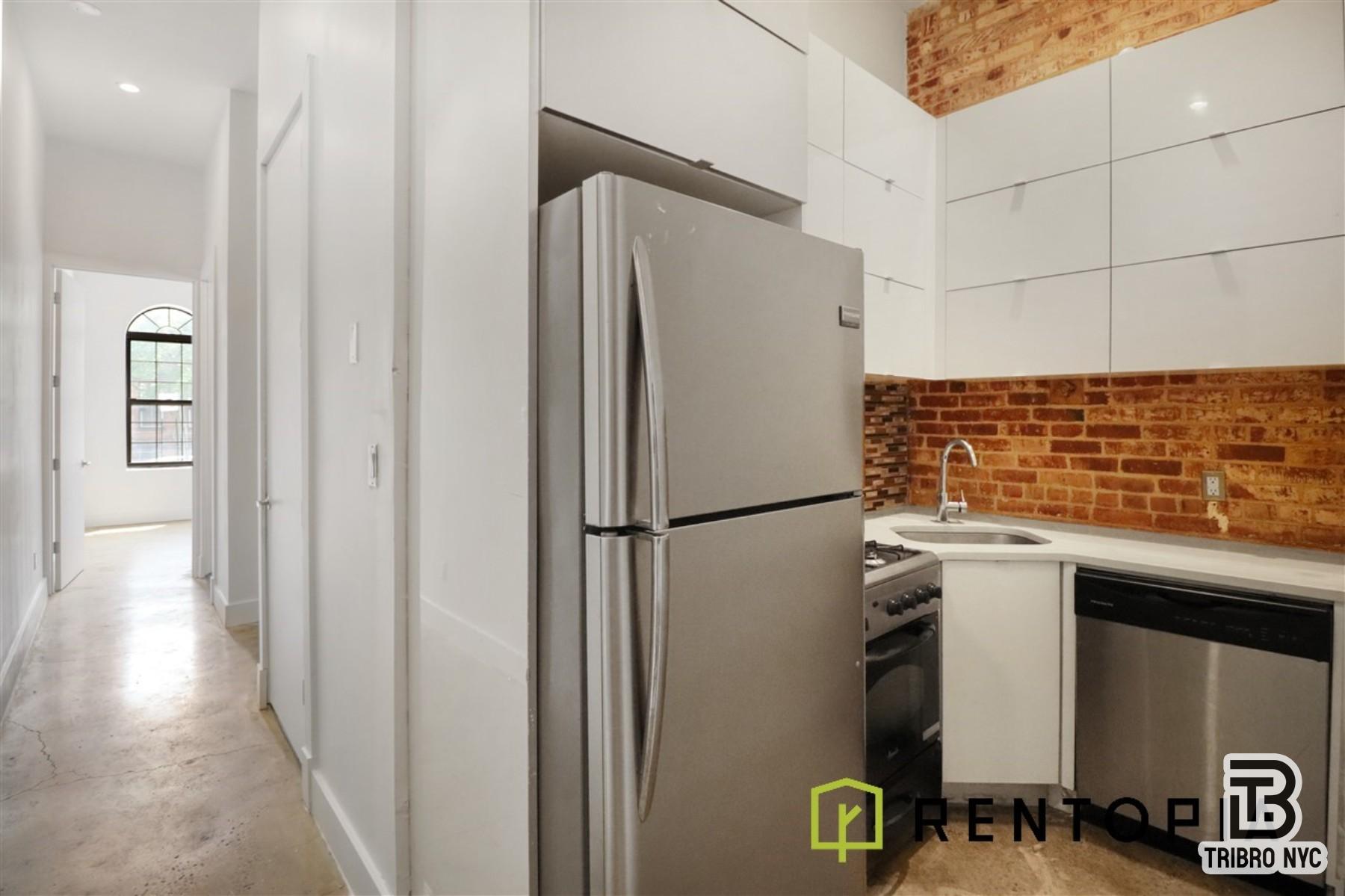 753 Lexington Avenue, Unit 1D Brooklyn, NY 11221 - Photo 6 of 8 a white refrigerator freezer sitting inside of a kitchen