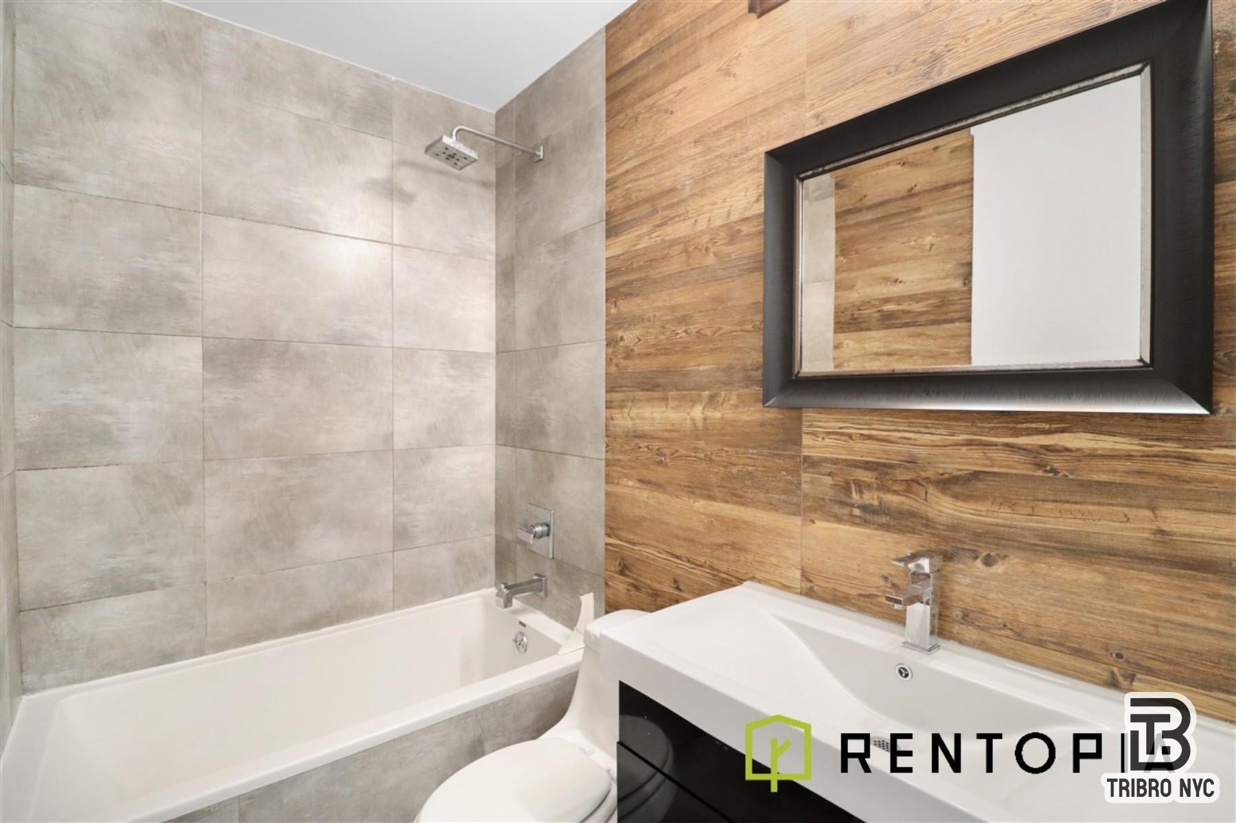 753 Lexington Avenue, Unit 1D Brooklyn, NY 11221 - Photo 7 of 8 a bathroom with a sink and a bathtub